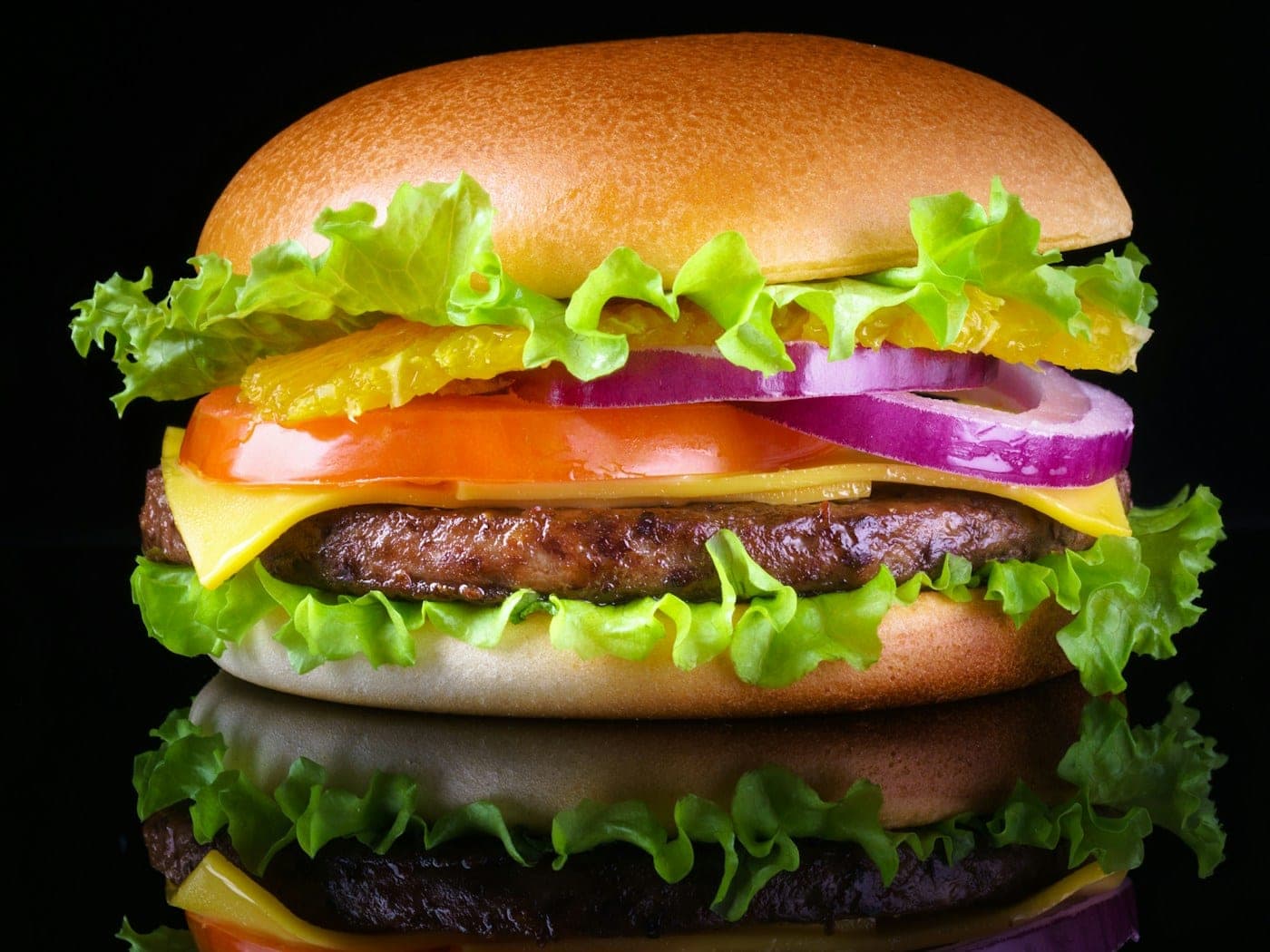 Burger being assembled on a steel counter