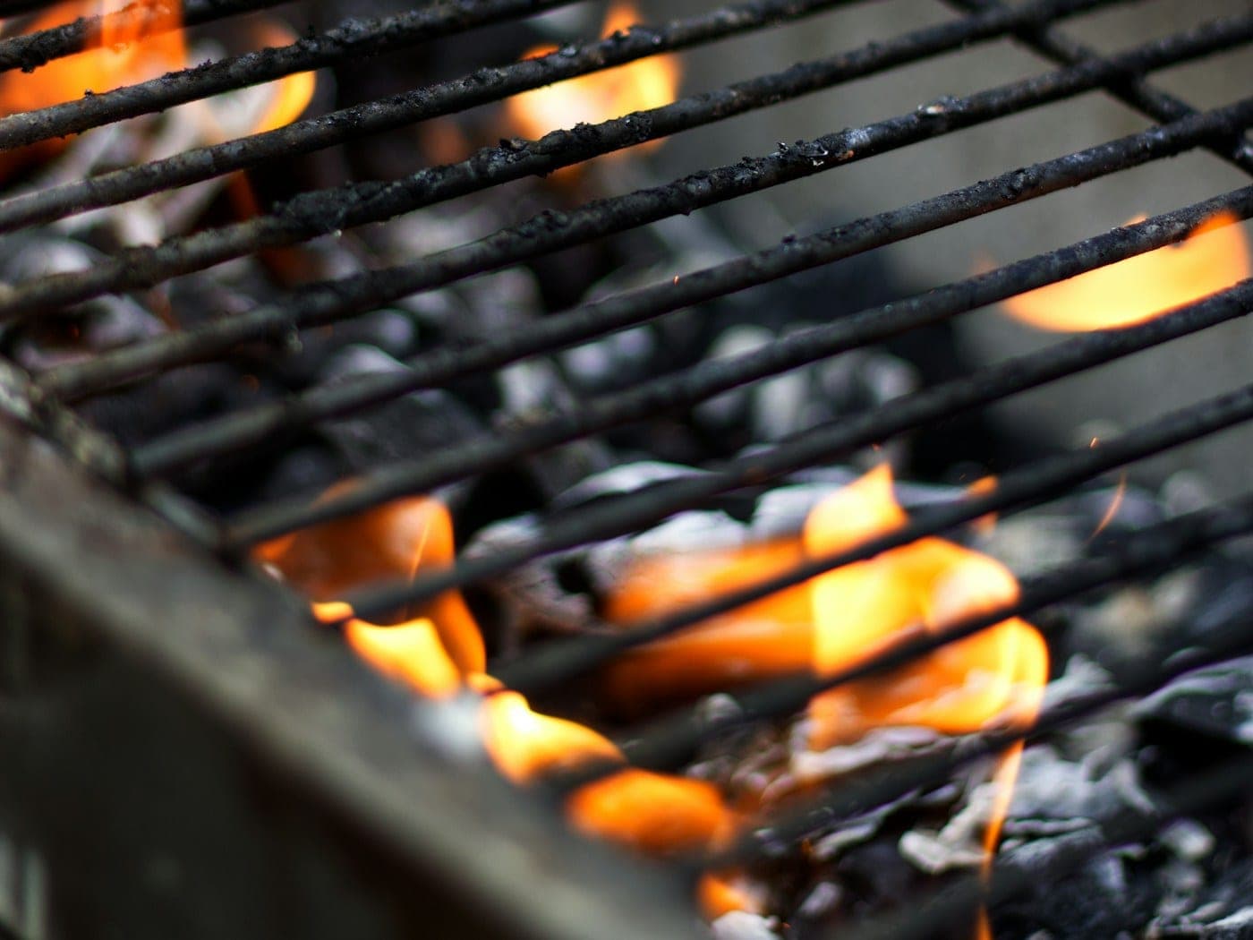 Hardwood charcoal glowing in the grill bed