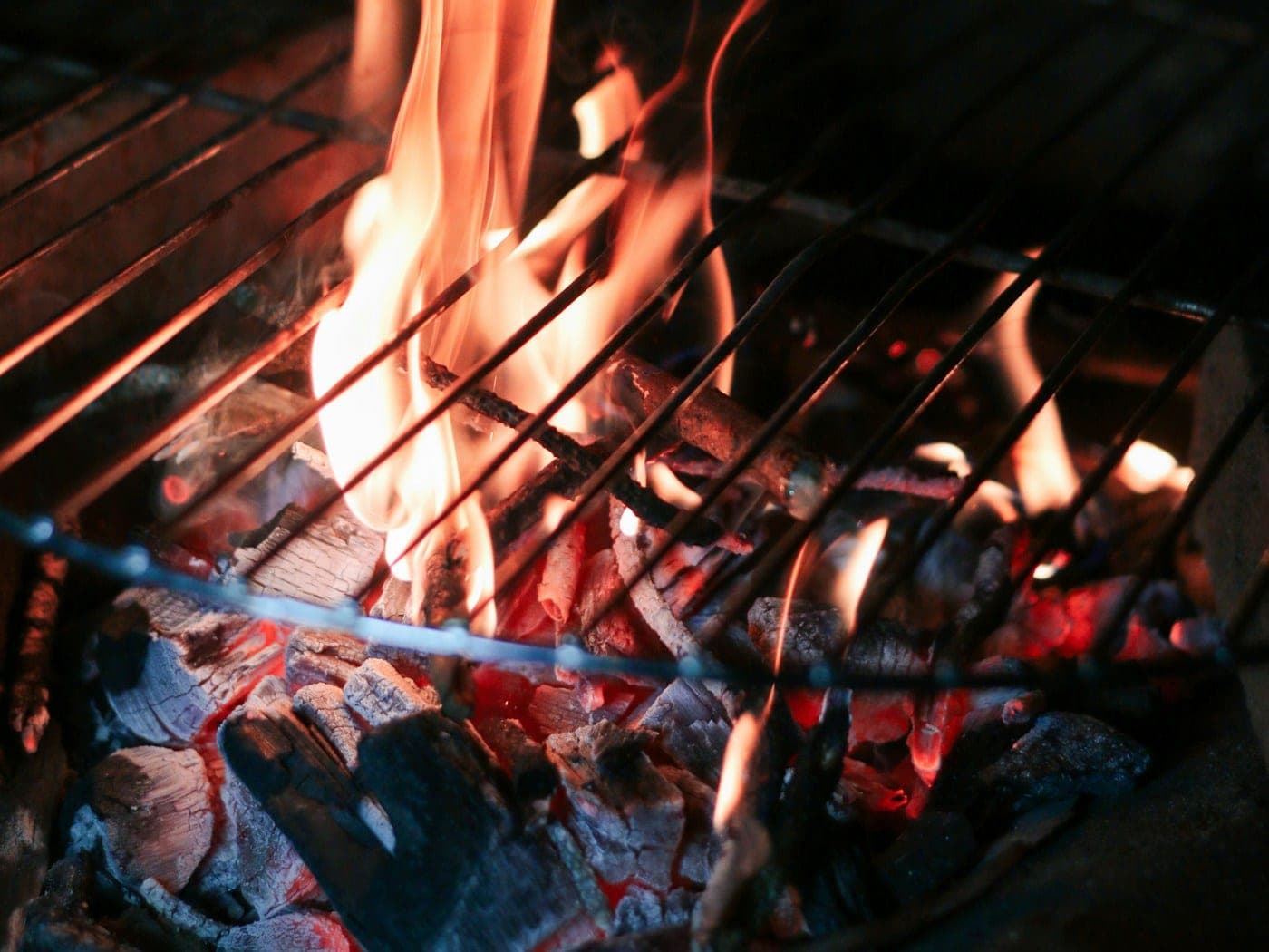 Steak searing over glowing charcoal