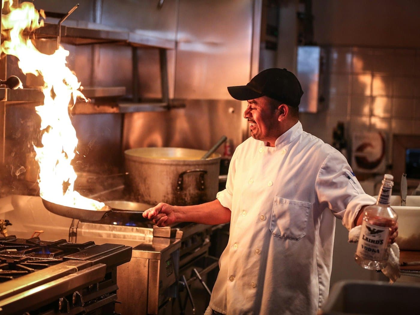 Chef working over an open charcoal grill